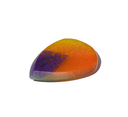 Right side angle of purple and orange resin guitar pick showing bevel profile