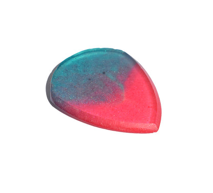Left side angle of teal and pink resin guitar pick showing bevel profile