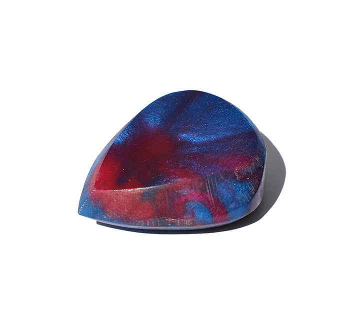 Right side angle of blue and red swirl resin guitar pick with bevel edge
