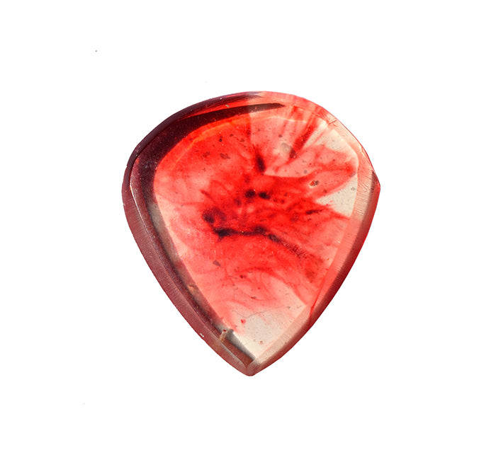 The front view of  a translucent red resin guitar pick with swirling darker red that looks like blood