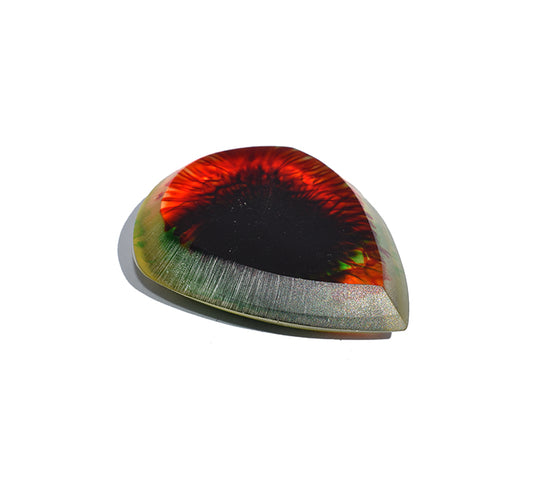 Left side angle of black and red swirl resin guitar pick showing bevel profile