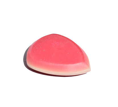 Left side angle of pink and red resin guitar pick showing bevel profile
