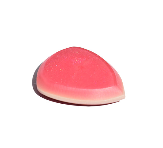 Left side angle of pink and red resin guitar pick showing bevel profile